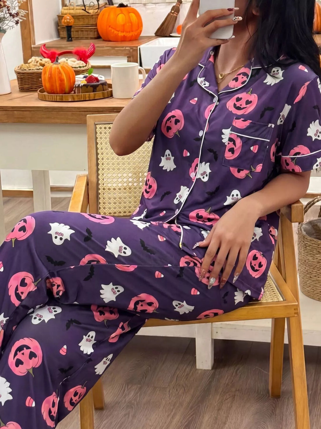 Halloween pajama set: purple button-up top and pants with bats, ghosts, and jack-o&