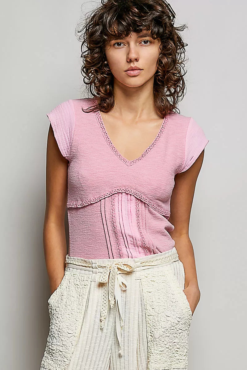 Soft pink V-neck lightweight knit top with lace-trim neckline and short sleeves