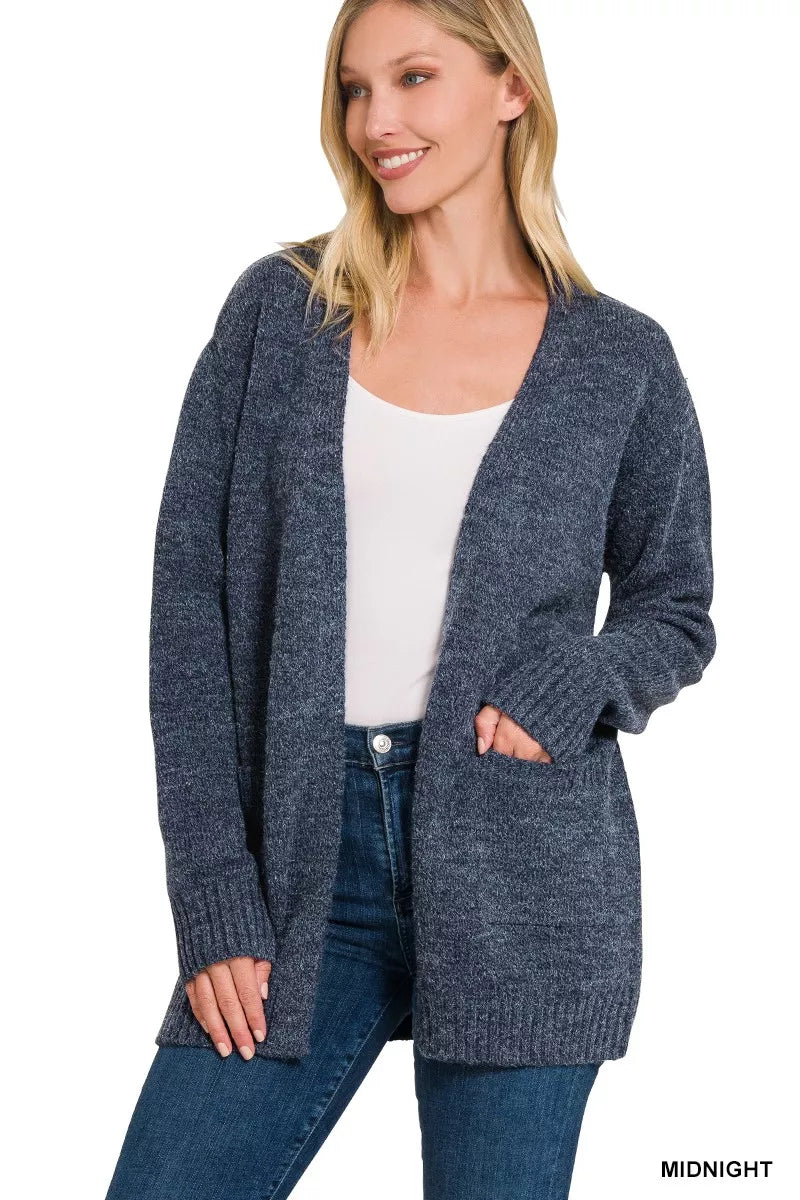 Midnight open-front knit cardigan with front pockets and long sleeves worn over jeans