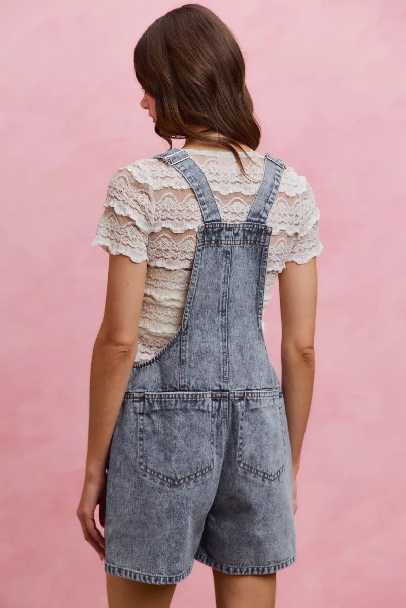 Light wash denim overall romper with adjustable straps and back yoke, two back pockets