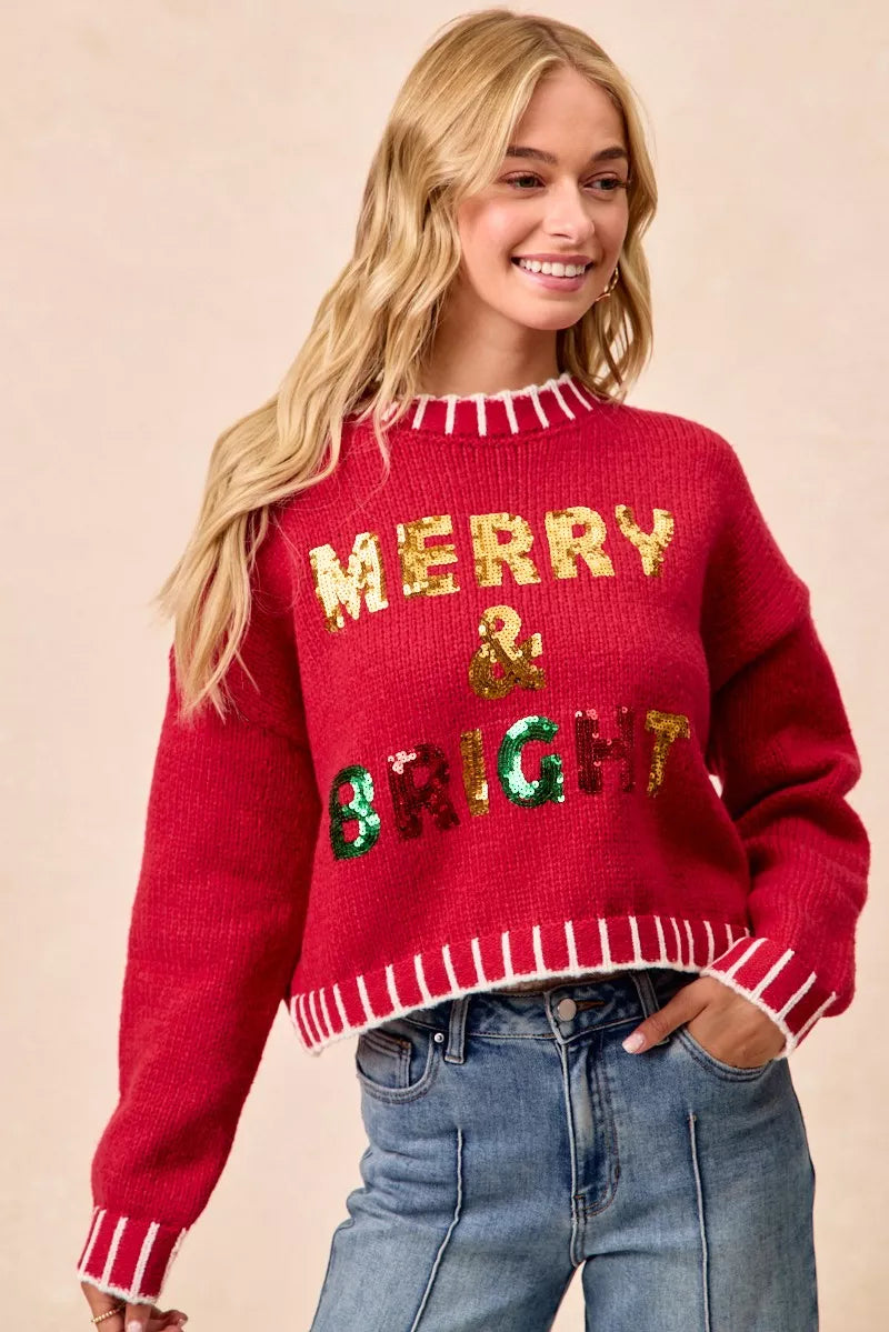 Red crewneck sweater with “Merry & Bright” sequin design and striped hem and cuffs