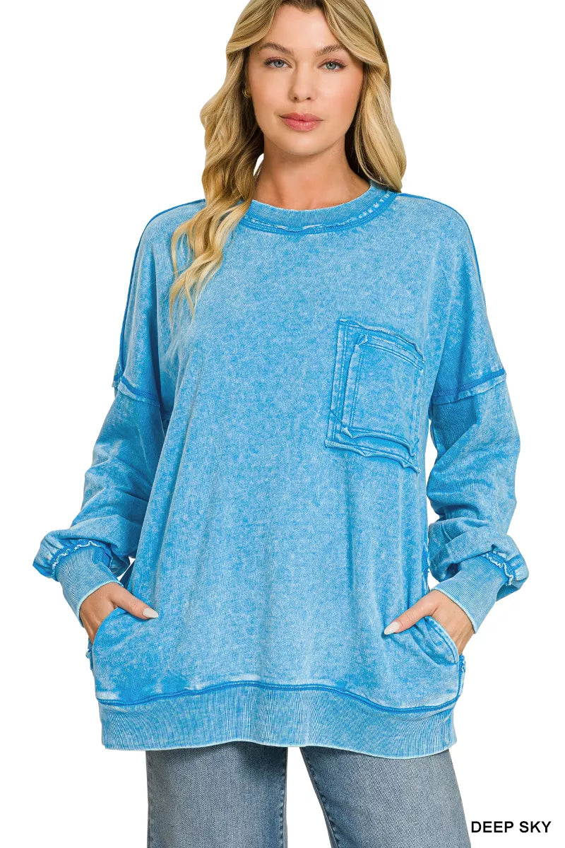 Blue acid-wash French terry sweatshirt with front pocket and raw-edge hemline