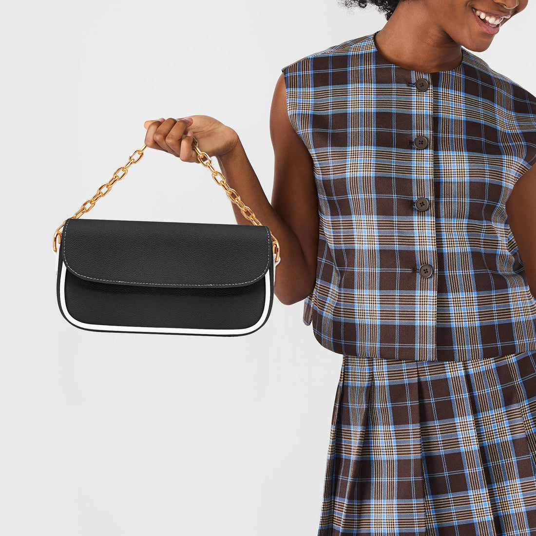 Black mini shoulder bag with flap and gold chain-link shoulder strap