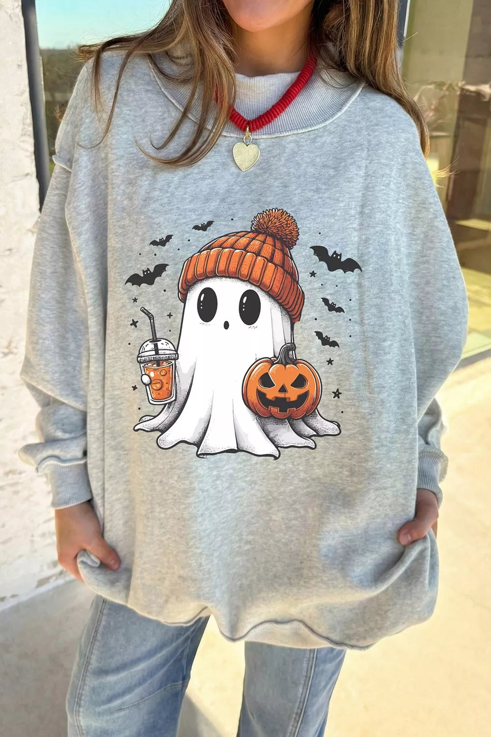 Reversible light gray mock neck tunic sweatshirt with ghost, orange pumpkin face, and bats graphic