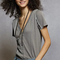 Grey pinstripe short sleeve top with V-neck and stitch seam detail, close-up
