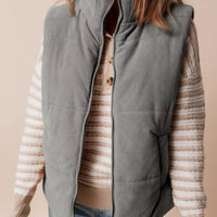 Gray corduroy puffer vest with stand collar, zip front, and chest opening detail.