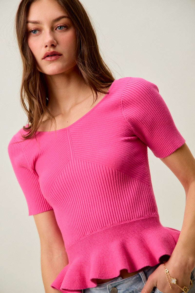 Hot pink ribbed knit peplum sweater top, short sleeves and ruffled hem detail
