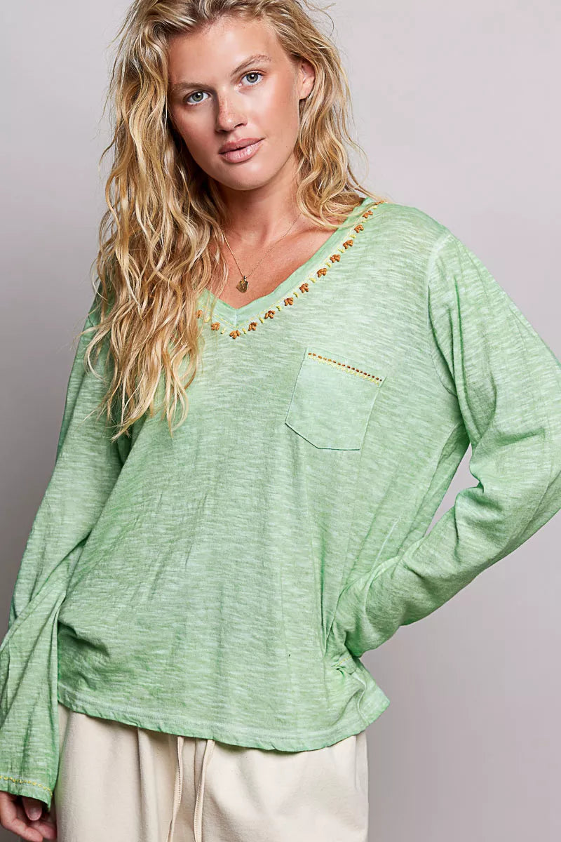 Light green V-neck knit top with embroidered trim and chest pocket