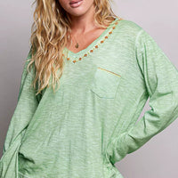 Light green V-neck knit top with embroidered trim and chest pocket