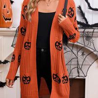 Orange open-front knit cardigan with black jack-o'-lantern pumpkin pattern