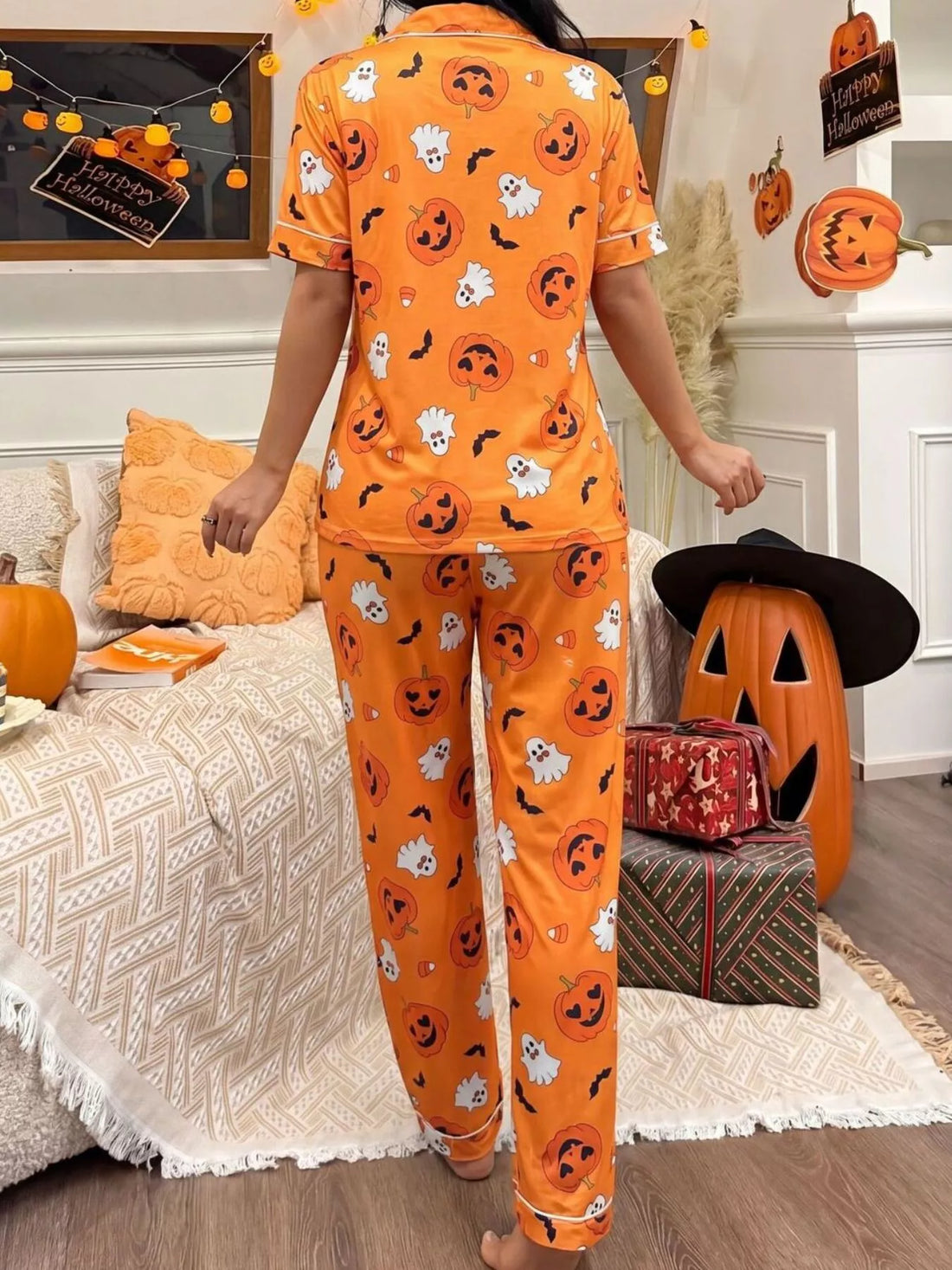 Halloween pajama set: orange button-up top and matching pants with jack-o&