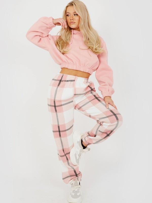 Light pink plaid joggers with elastic waist and drawstring ties.