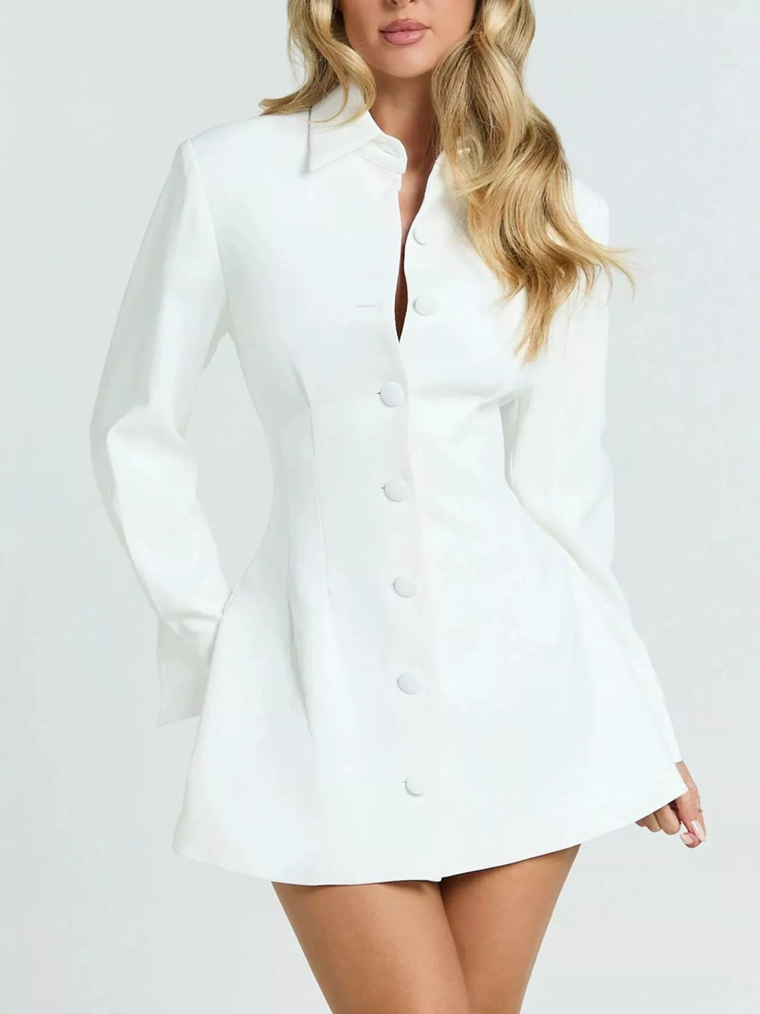 White blazer-style mini dress with notched collar, long sleeves, and button front.