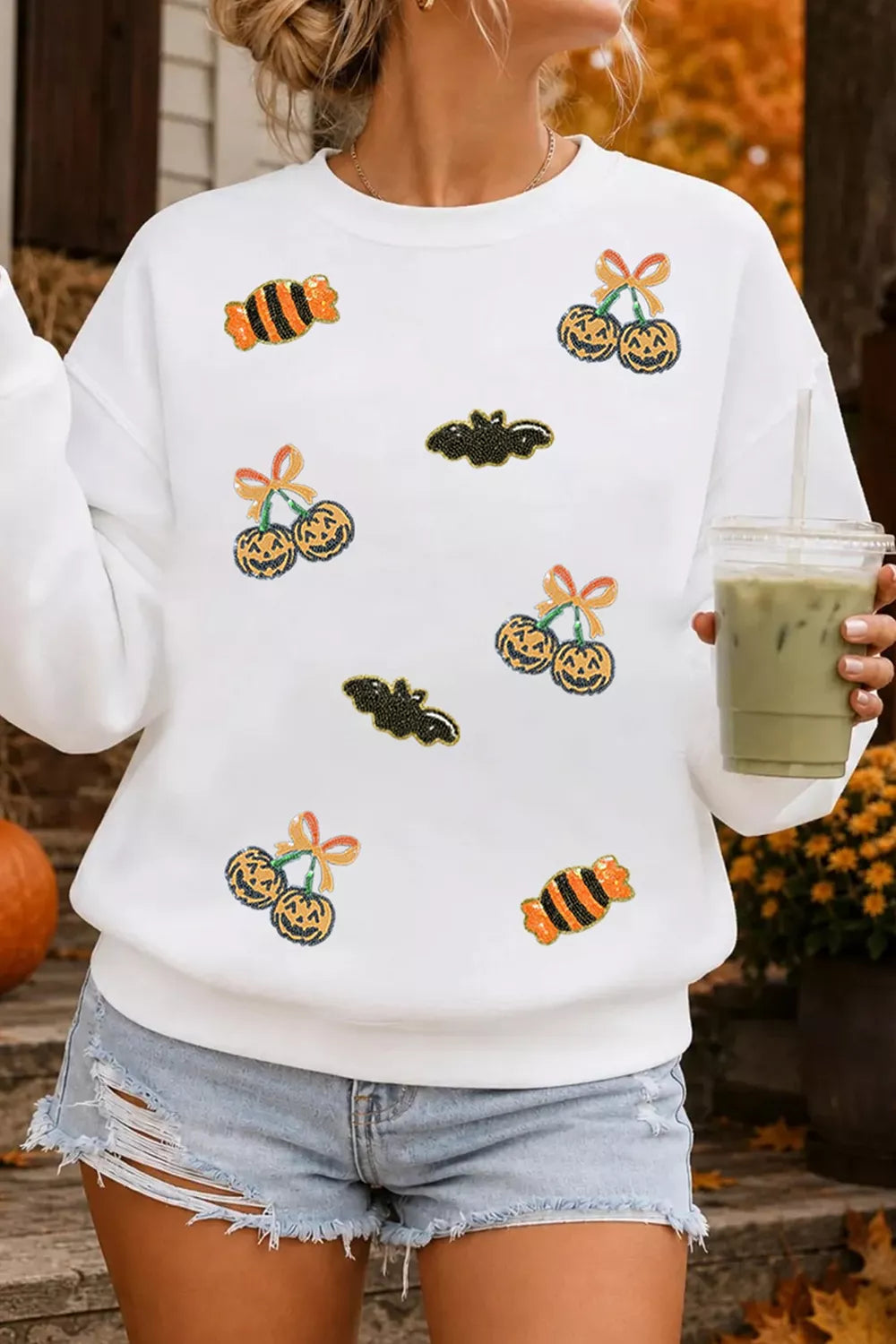 White sequin pullover sweatshirt with Halloween jack-o&