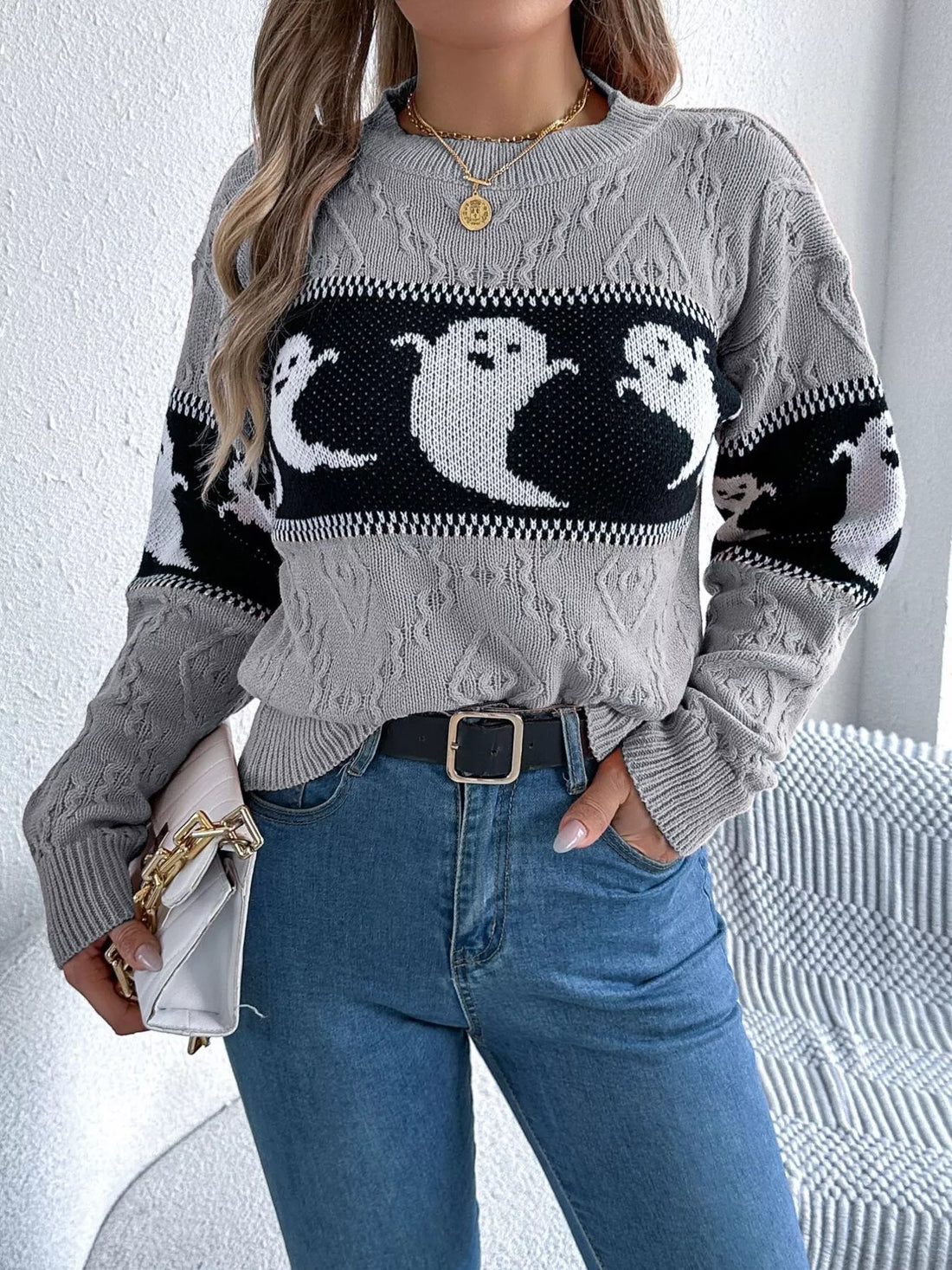 Gray textured knit sweater with black-and-white ghost pattern on the chest and sleeves