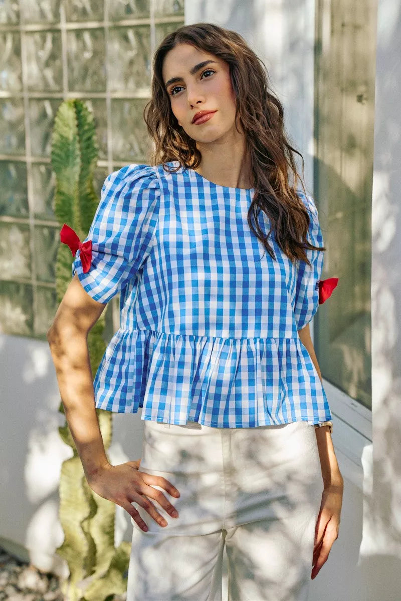 Blue gingham short-sleeve blouse with side bow detail and peplum hem