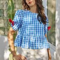 Blue gingham short-sleeve blouse with side bow detail and peplum hem