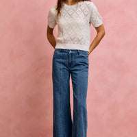 Women's mid-rise stretch denim jeans with seam detail, wide-leg fit