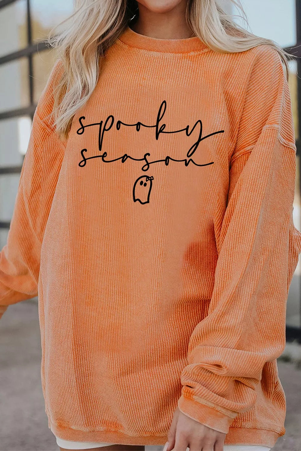 Orange ribbed pullover sweatshirt with “sprooky season” print and long sleeves