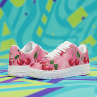 Pink sneakers with cherry design on a colorful abstract background