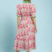Back view of floral tiered midi dress in pink mix with puff sleeves and green trim