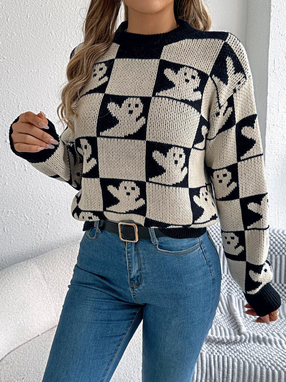 Ghost-pattern checkered round-neck sweater in black and cream with crew neckline.