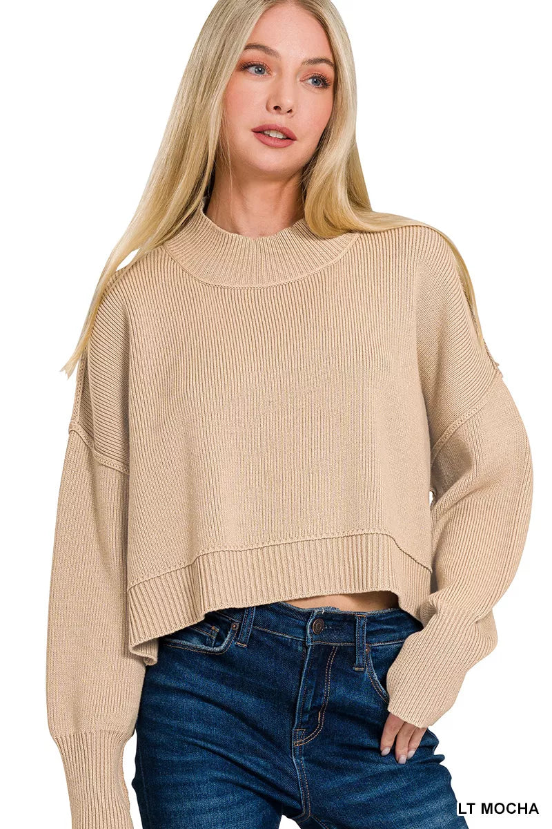 Light mocha oversized cropped sweater with ribbed high neckline and side slits