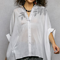 Ivory embroidered floral button-front high-low shirt, front view with V-neck collar