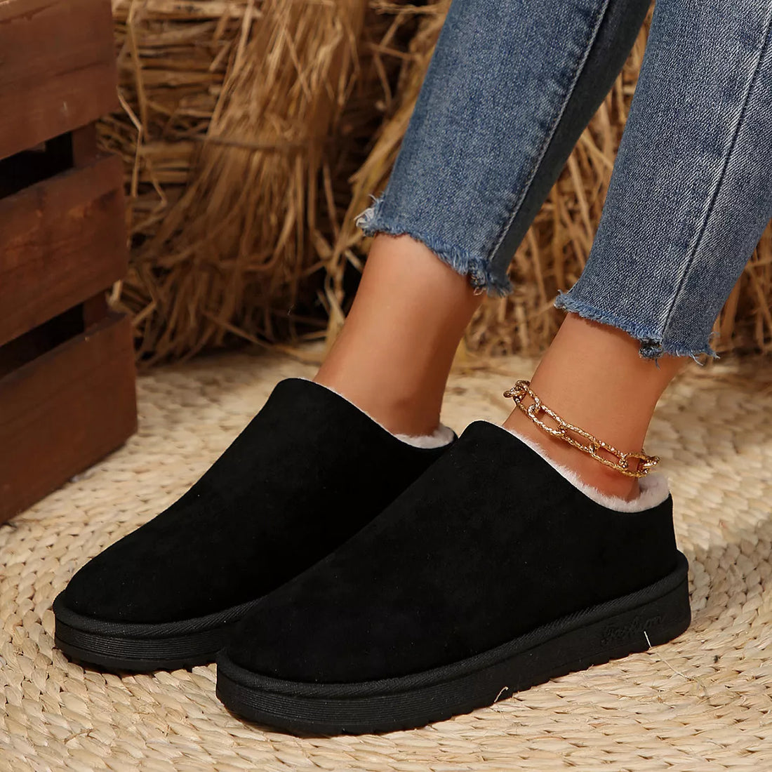 Black plush lined ankle boots with round toe, white fur trim, slip-on style.