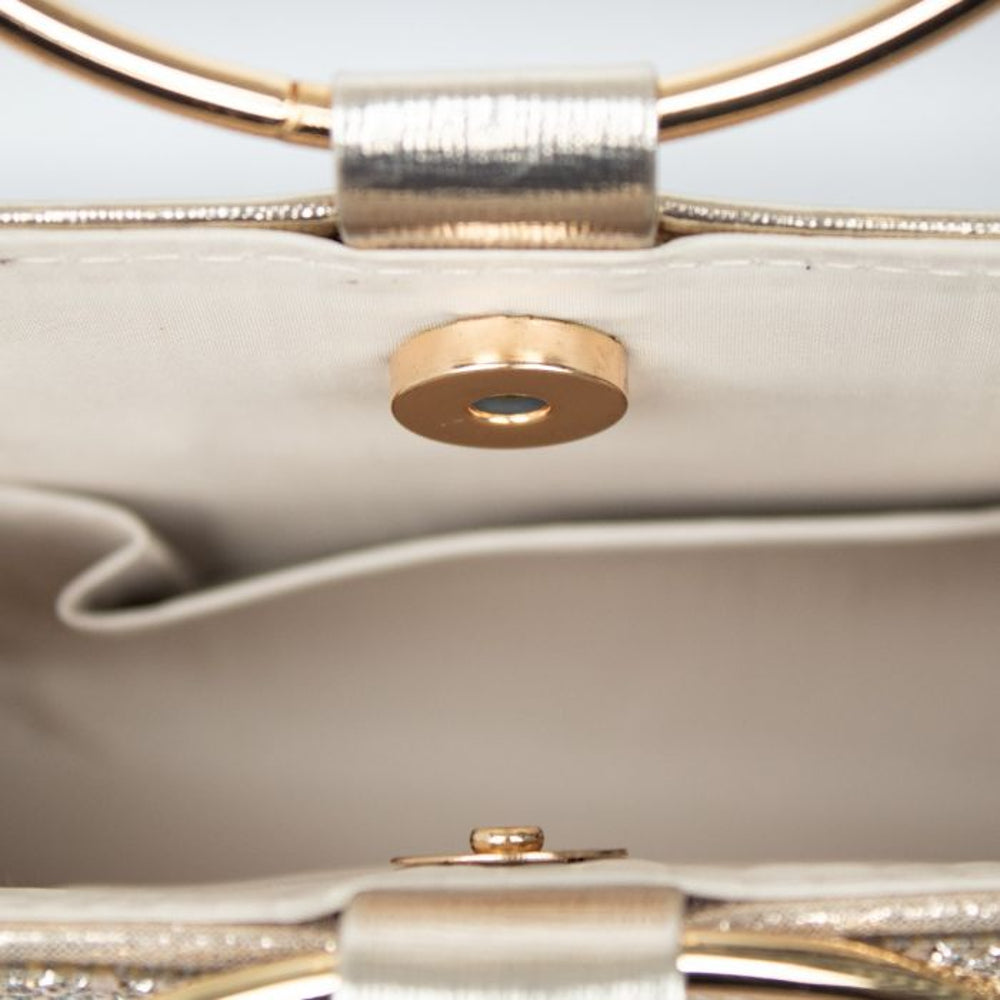 Close-up of gold double ring handle and snap clasp on clutch bag