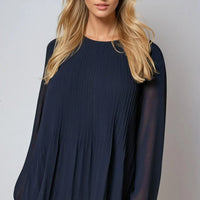 Navy long-sleeve pleated blouse with loose drape and round neckline