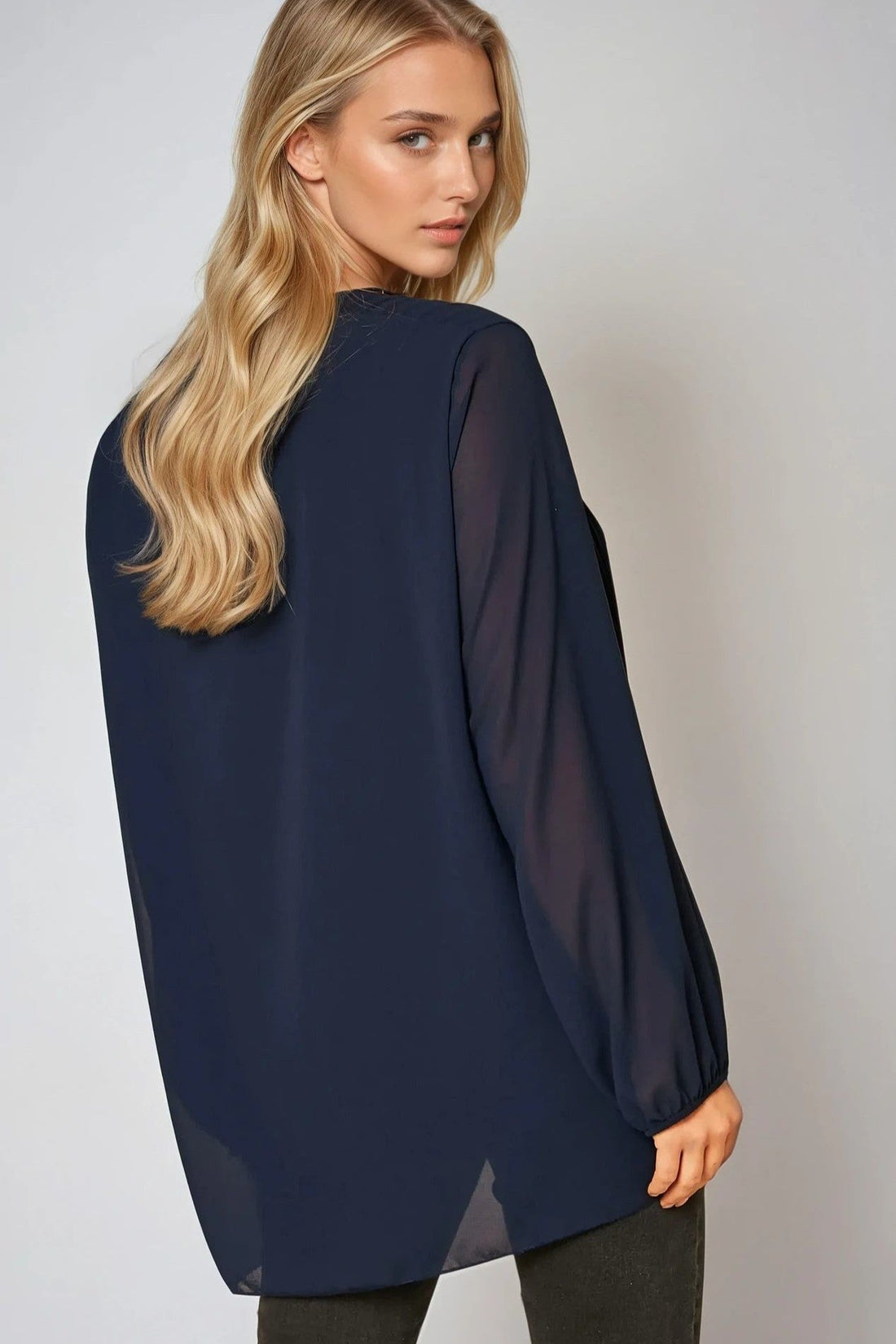 Navy long-sleeve pleated blouse, back/side view with gathered sleeves