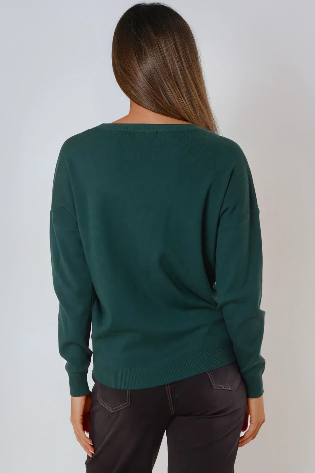 Back view of green fine-knit crew neck jumper with ribbed cuffs