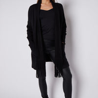 Black fringed cardigan with shawl collar, open front, and long tassel trim
