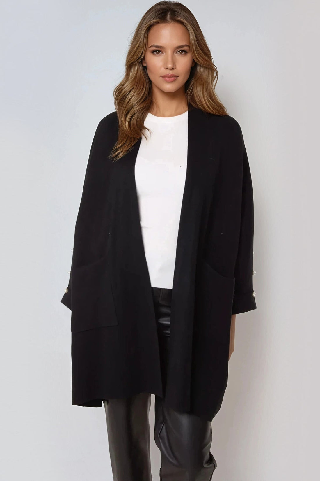 Black open-front cardigan with pearl sleeve detail and side pockets
