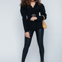 Black puff-shoulder blouse with V-neck, belted waist and peplum hem