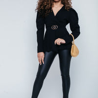 Black puff-shoulder V-neck blouse with ring-buckle belt and peplum hem