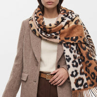 Leopard-spotted print scarf in brown and cream with color blocks and tassel fringe