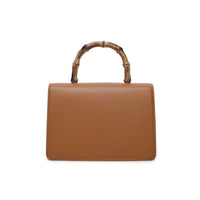 Brown faux leather crossbody bag with bamboo-style handle and simple top front