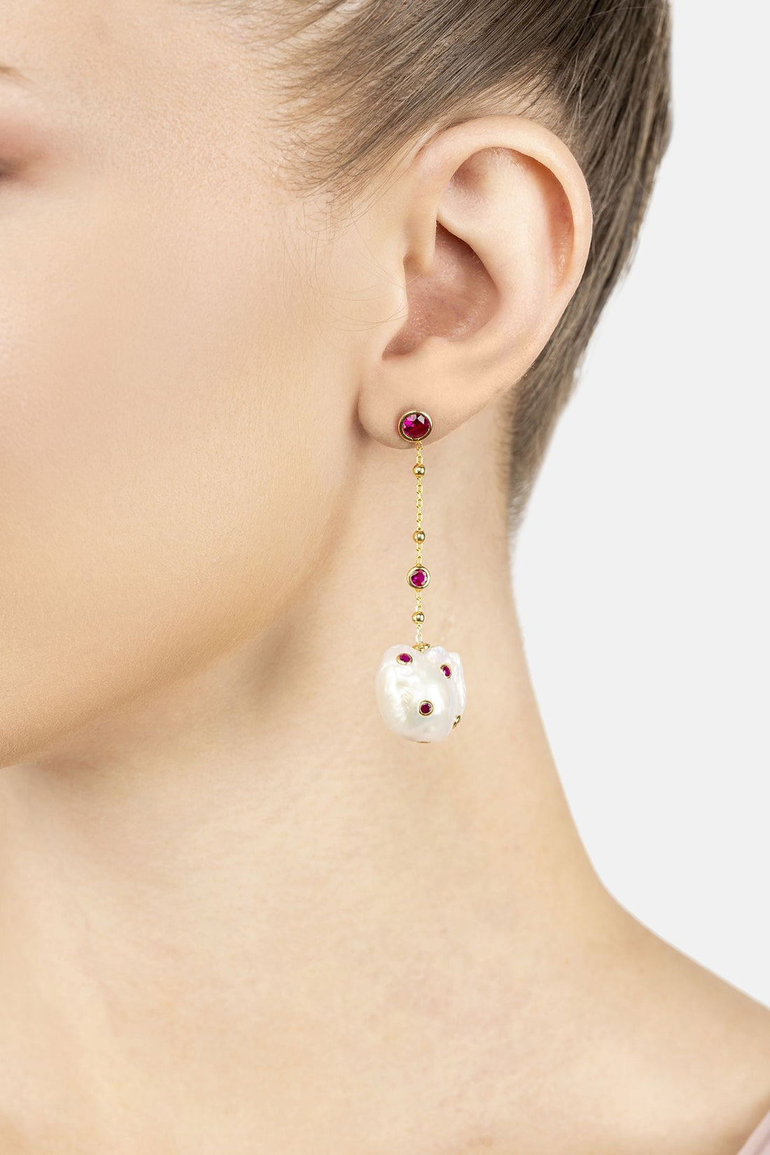 Gold-tone dangle earrings with pearl beads, red ruby accents, and white baroque pearl charm