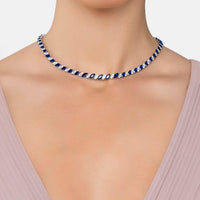Sapphire blue tennis necklace worn at collar, silver-tone chain with crystal links