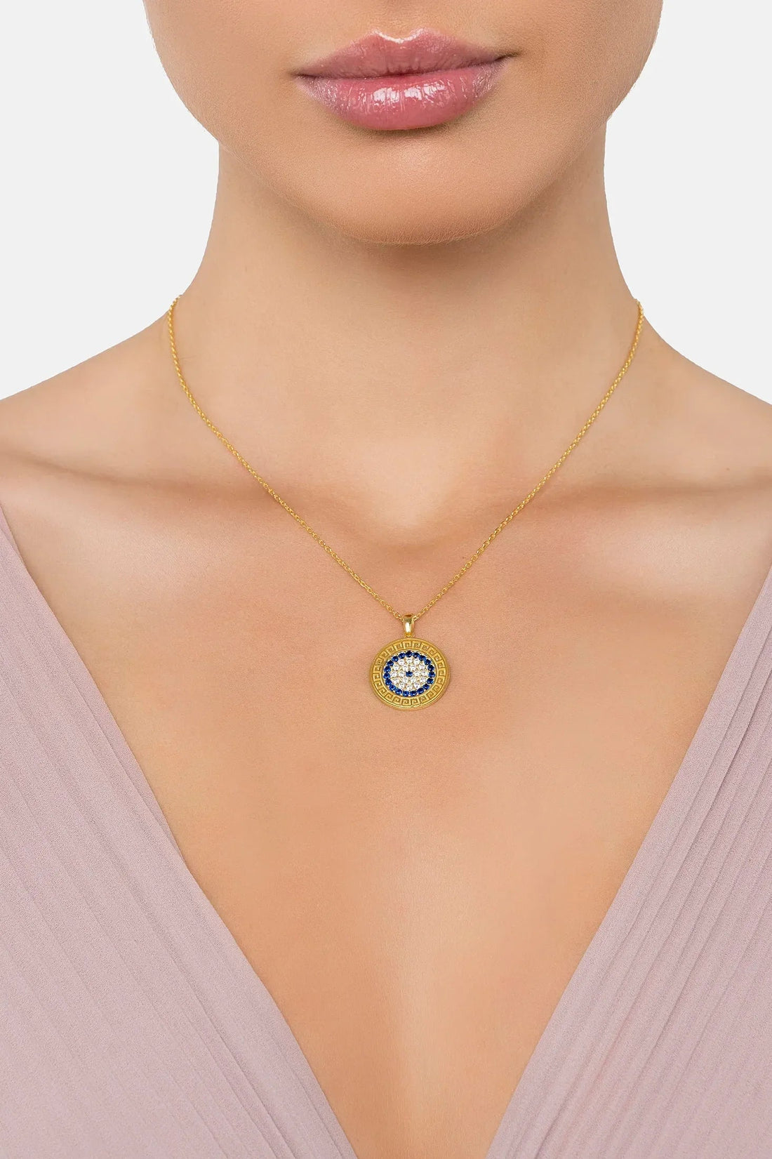 Gold evil eye disc pendant necklace with blue center and white stone border