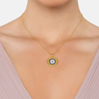 Gold evil eye disc pendant necklace with blue center and white stone border
