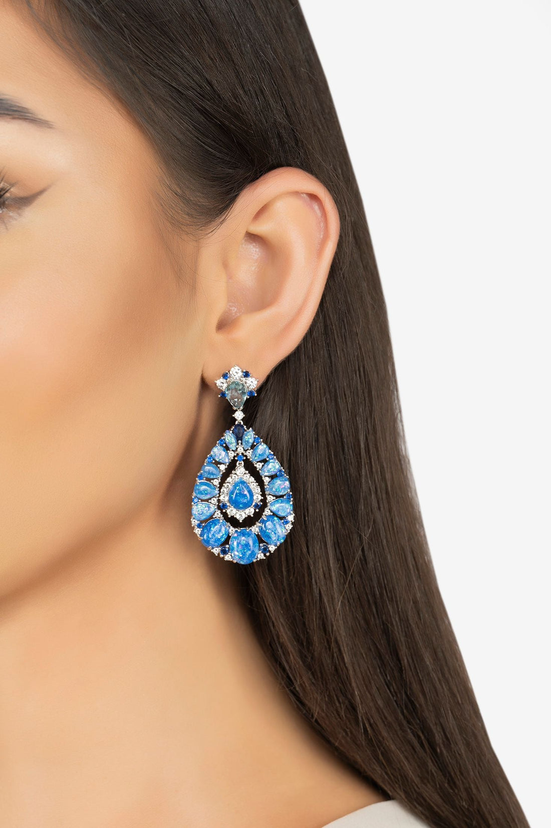 Silver drop earrings with blue teardrop gemstone cluster and hoop-like backing