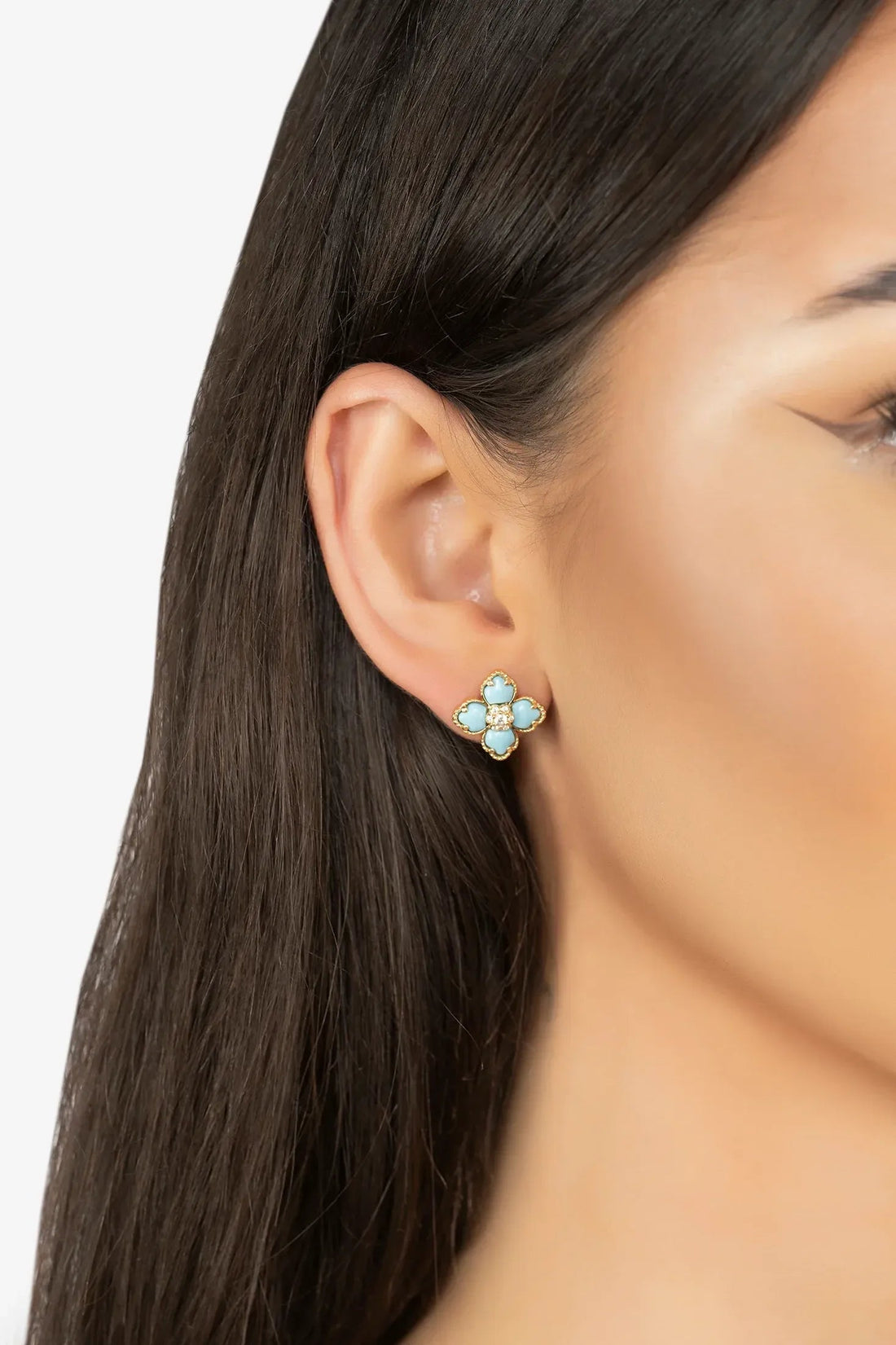 Gold-tone clover turquoise stud earrings with crystal center on ear