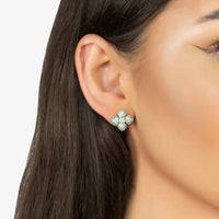 Gold-tone clover turquoise stud earrings with crystal center on ear