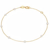 14k gold pearl spaced bracelet with round white pearls and lobster clasp