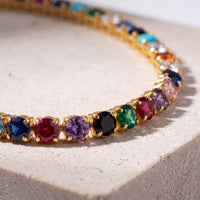 Rainbow CZ tennis necklace detail, multicolor stones set on gold links