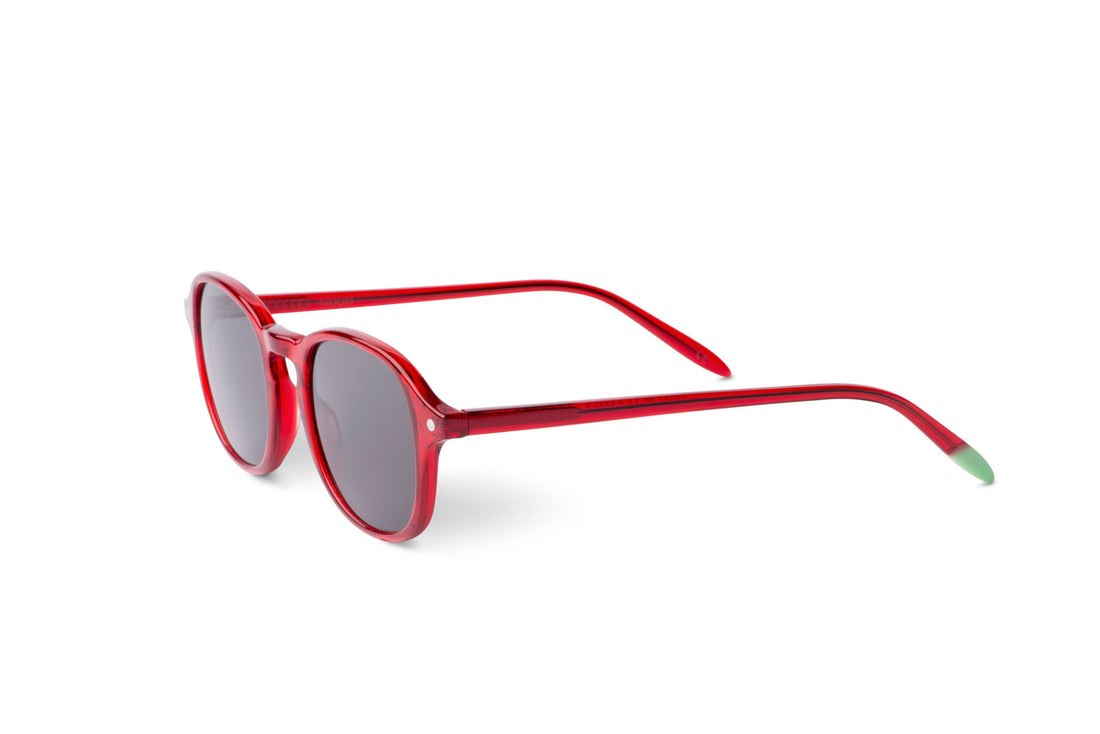 Red round sunglasses with dark tinted lenses and green-tipped temple arms