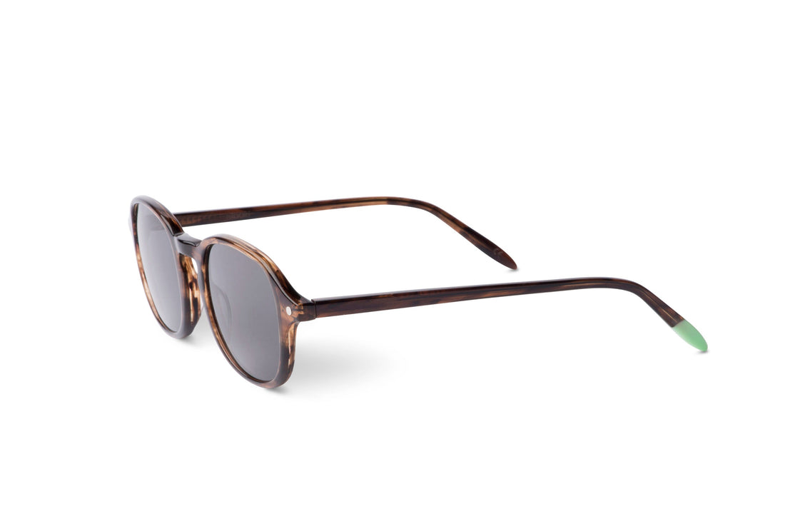 Smoky brown sunglasses angled view with dark smoke lenses and green temple tips